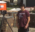 Still image of young man performing a laser scan of a house